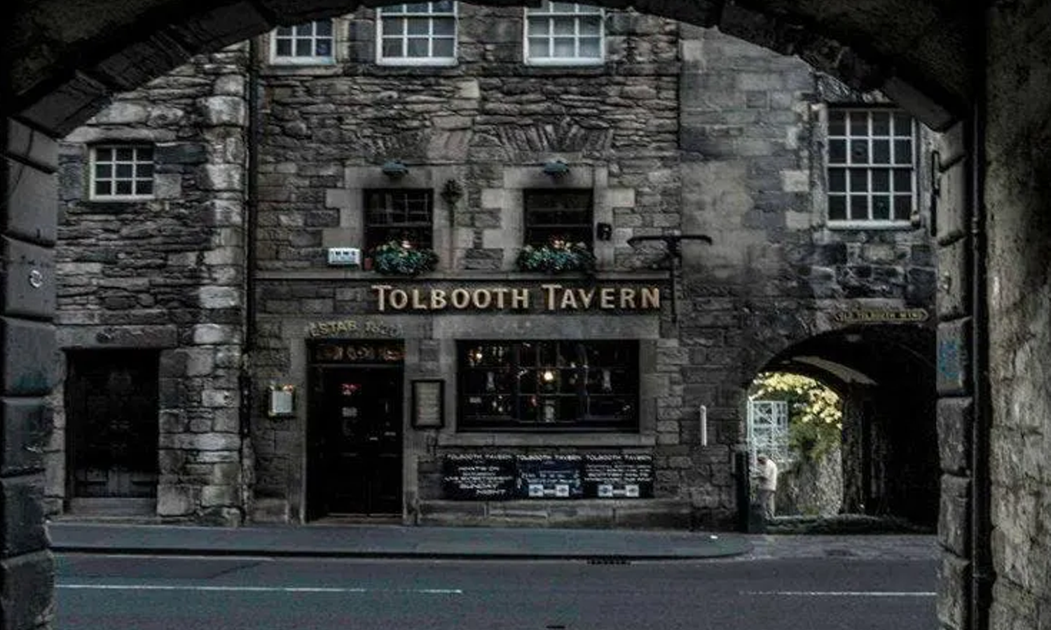 Image of Tolbooth Tavern. A quaint tavern with grey bricks in an old street.
